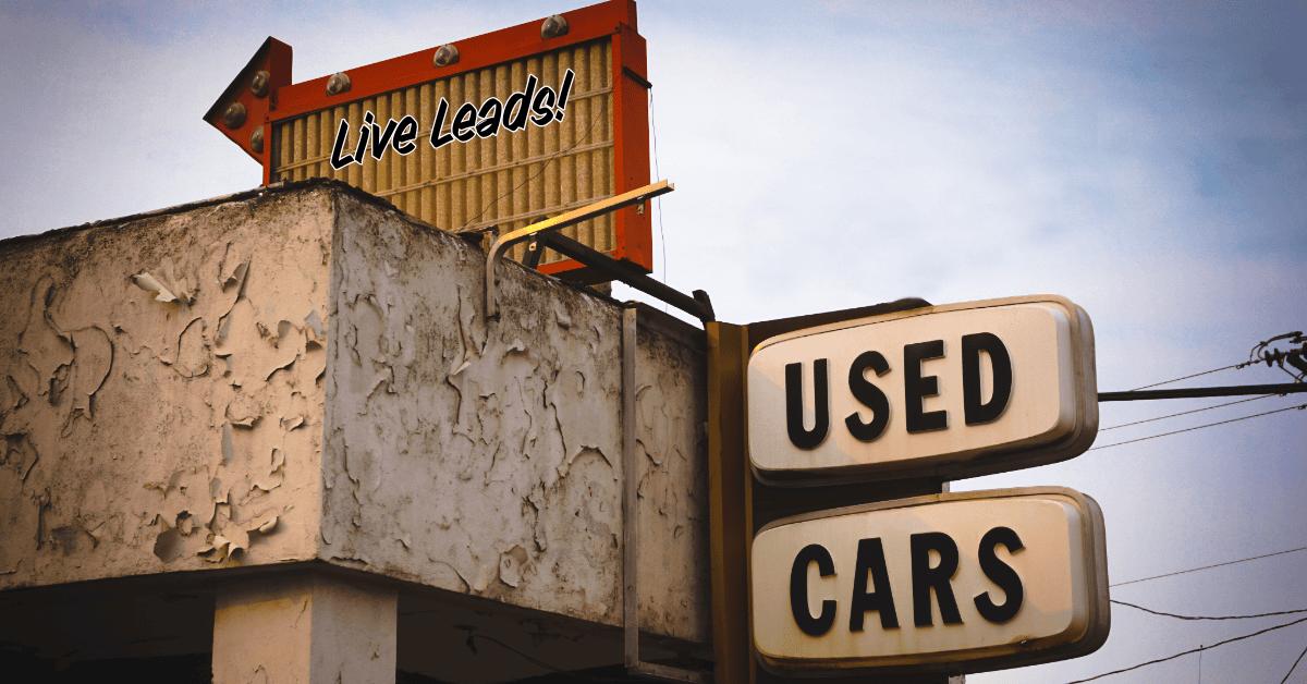Vintage "Used Cars" neon sign with "Live Leads" arrow sign above, representing lead generation and customer acquisition strategies